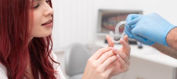 Woman asking questions of her dentist about Invisalign.