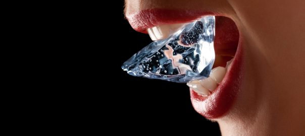 Woman chewing on ice cube